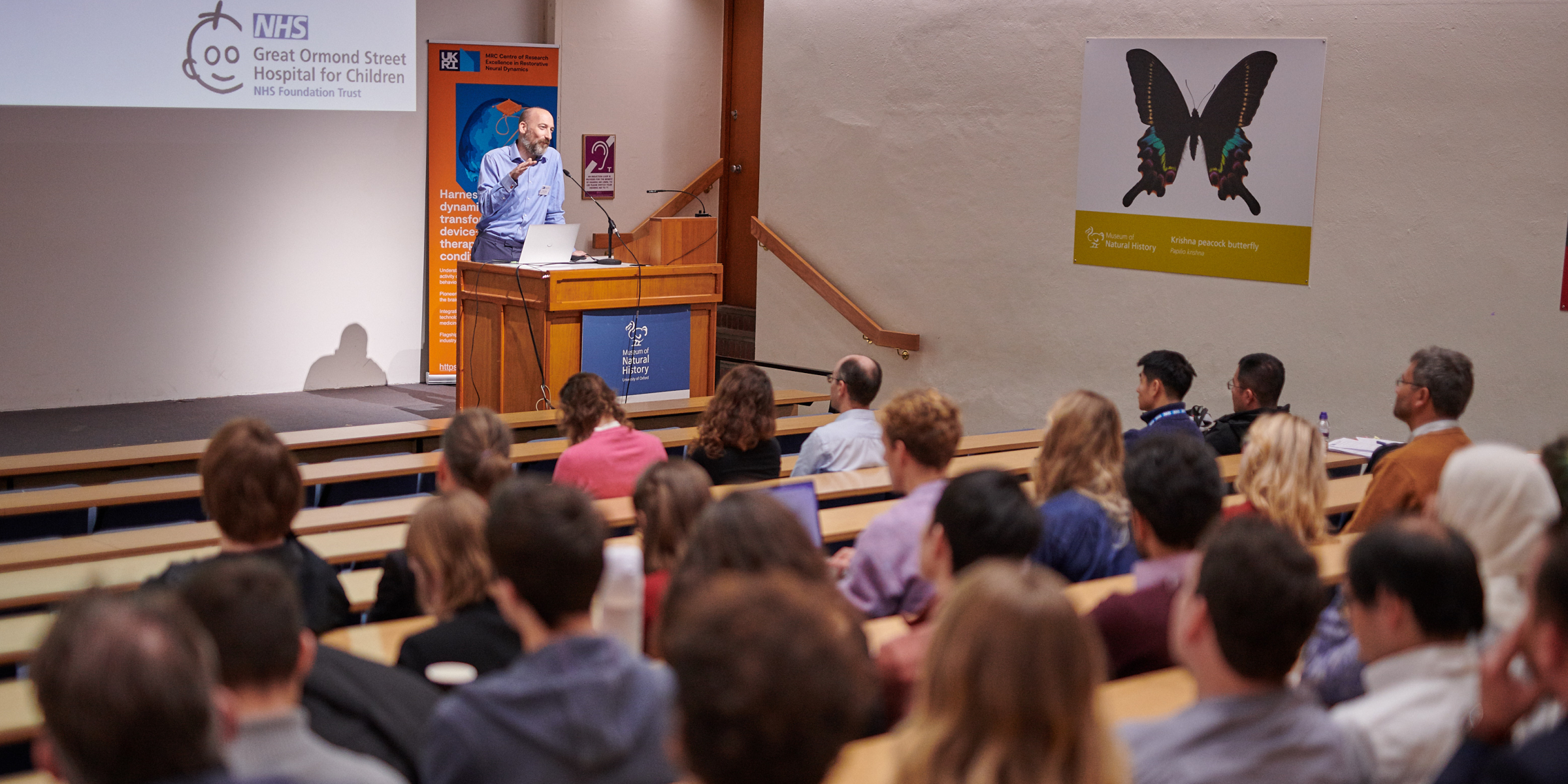 an audience listens to a speaker