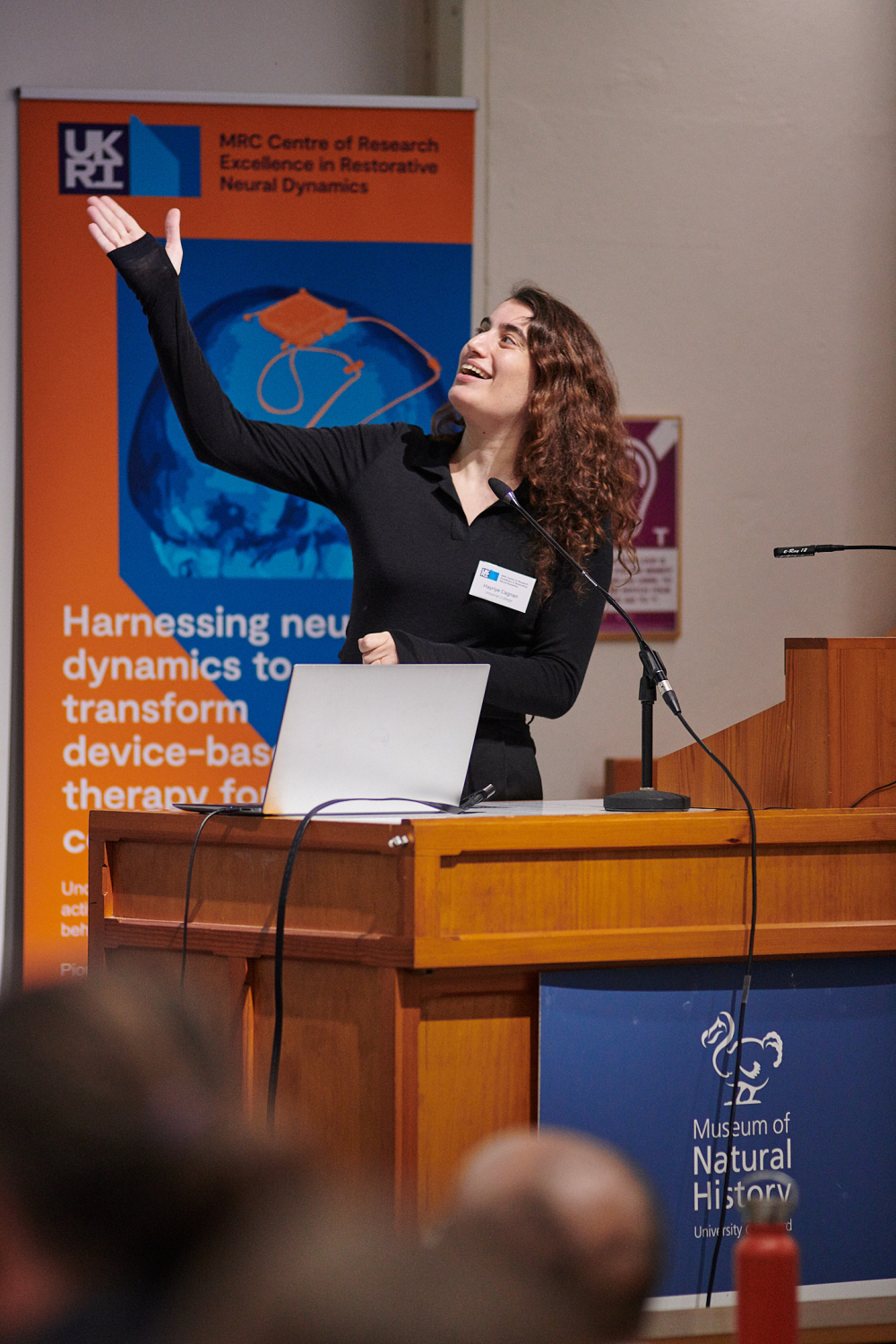 A researcher jestures at their slides