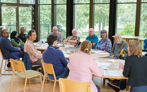 a photo of the whole group around a table